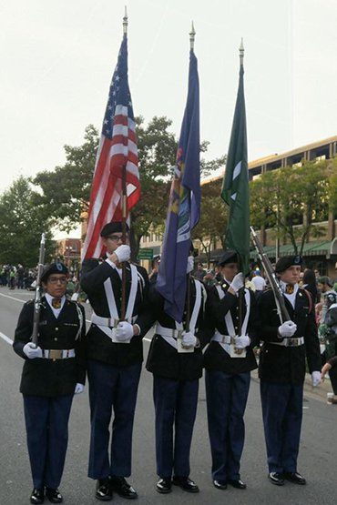 color guard starting off the homecoming parade in dress uniform