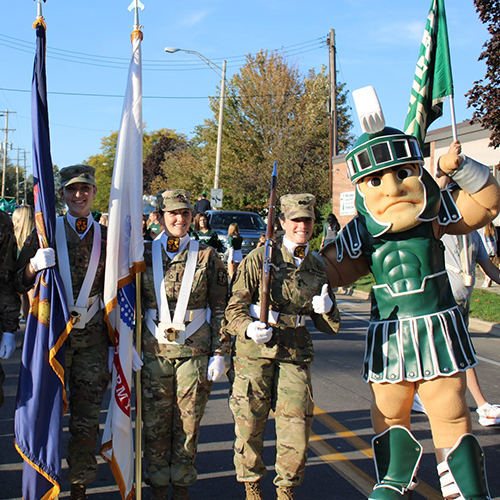 Sparty pictured with cadets during the homecoming parade