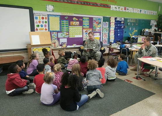 photo of students being read to by army staff